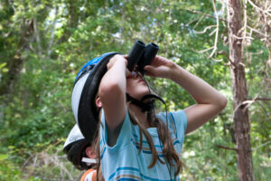 child using binoculars